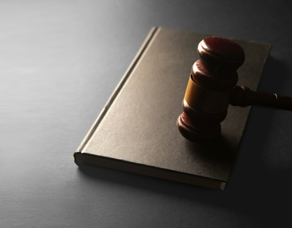 A wooden gavel resting on a closed law book, illustrating Thailand's draft Cannabis Control Bill